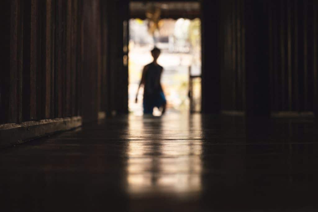 silhouette of boy going through a door
